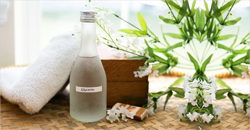 A clear bottle on glycerin with plants and home goods in the background.